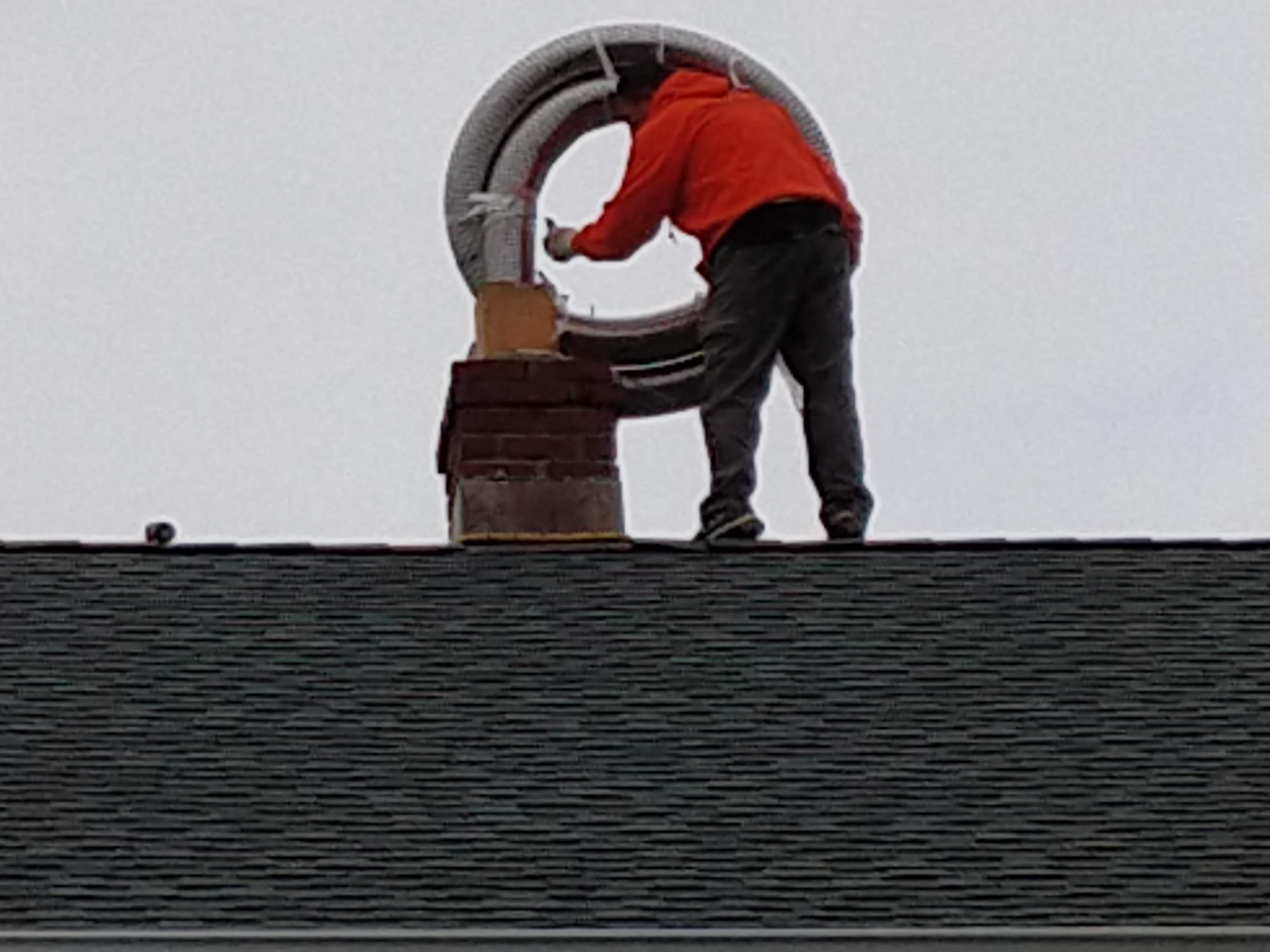 Flexible stainless chimney liner being installed in Uniondale, New York